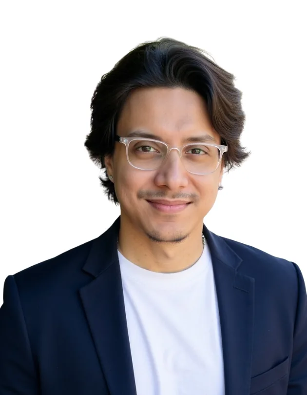 Portrait of Diptak Das in a navy blazer and clear-framed glasses